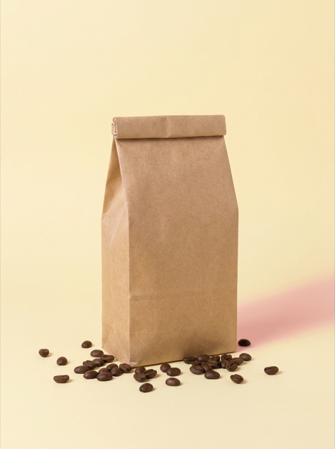 Kraft coffee bag on a butter yellow background